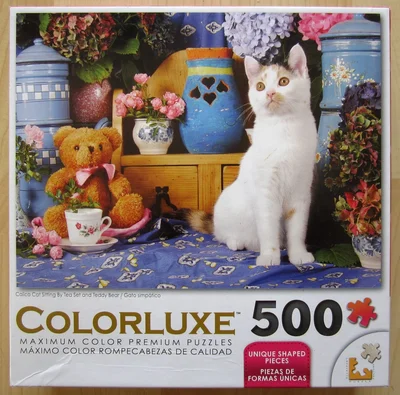 Calico Cat Sitting By Tea Set and Teddy Bear